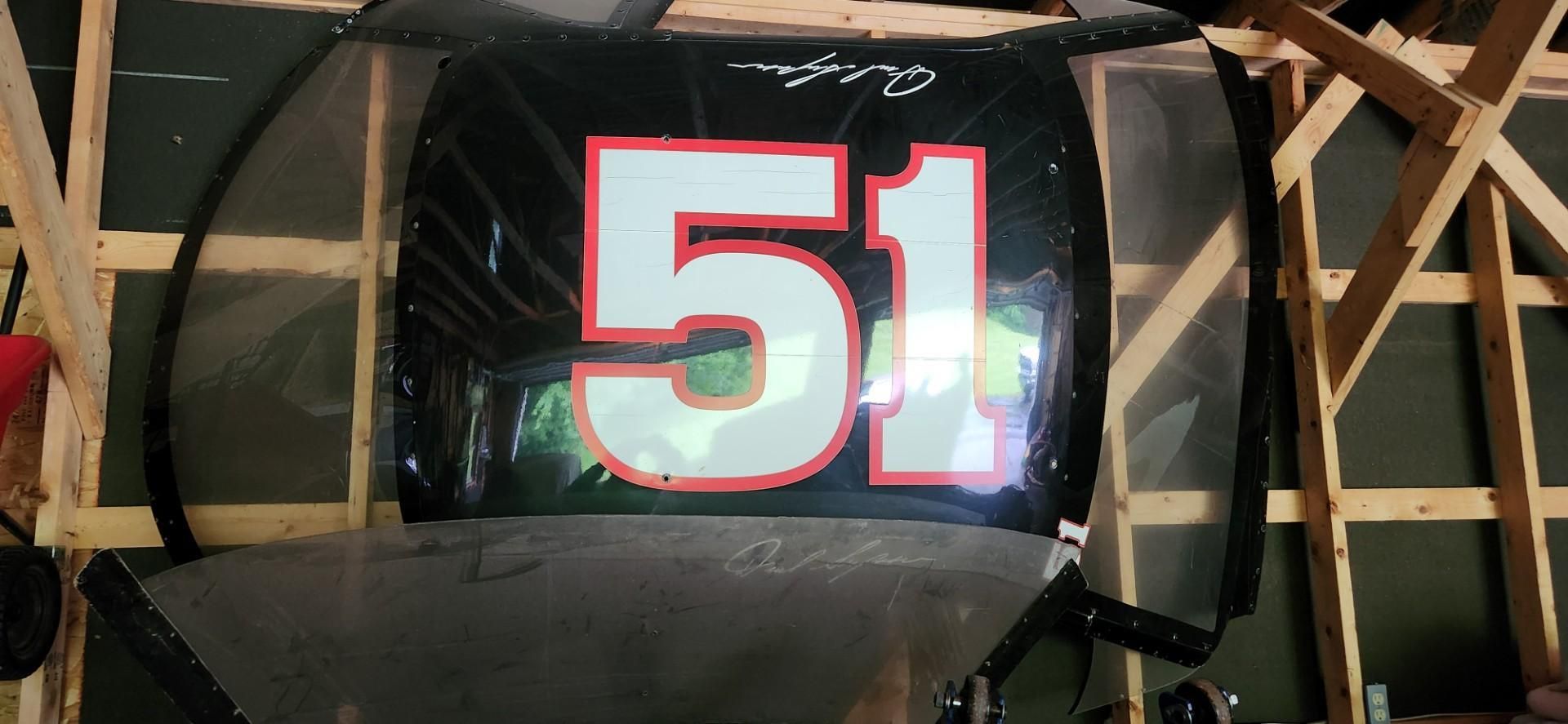 Black banner with a large white and red number 51 on a wooden frame
