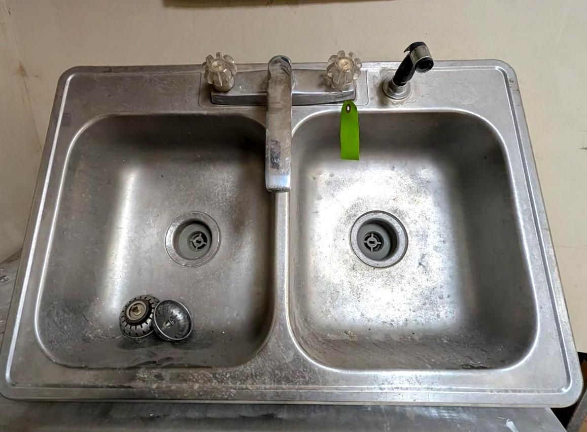 Double kitchen sink with two faucets