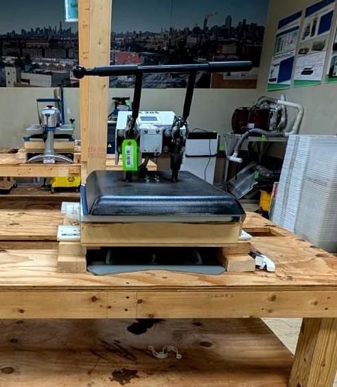 3D printer on a wooden workbench in a workshop