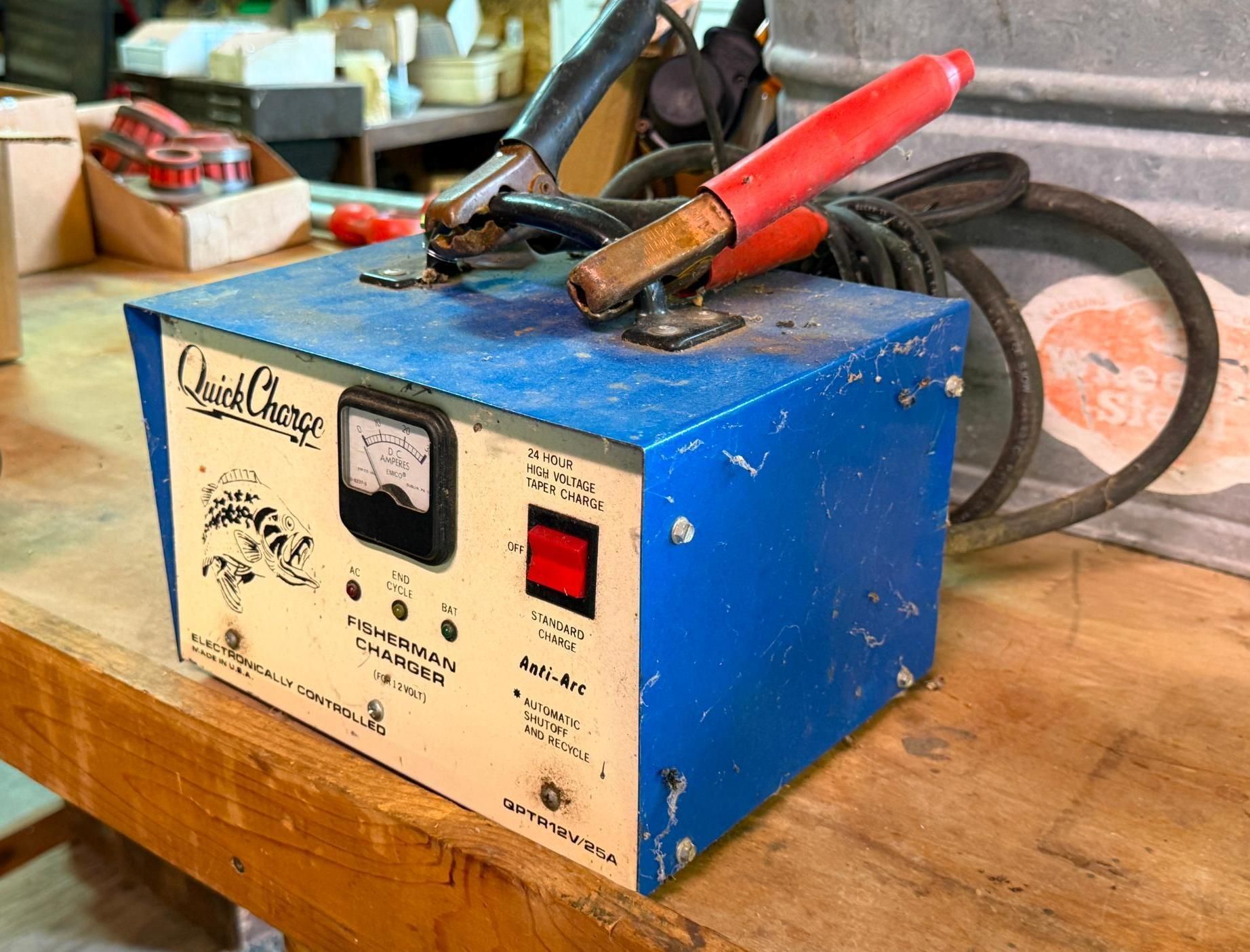 Blue machine on a wooden workbench with red and black clamps on top