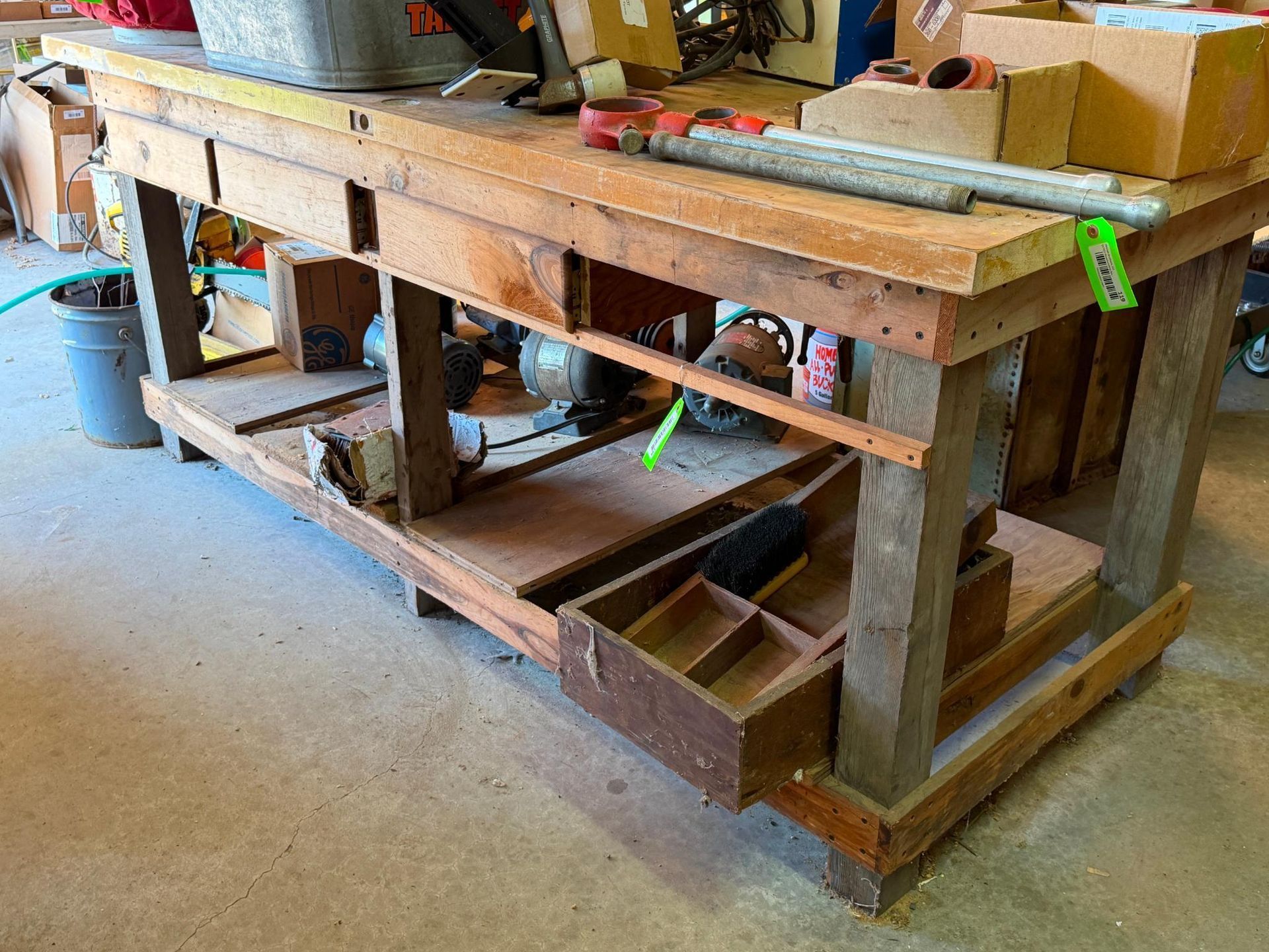 Wooden workbench with shelves, bins, and tools in a workshop garage