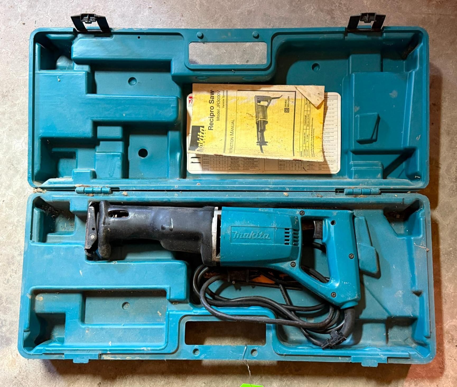 Blue hard case containing a cordless reciprocating saw and instruction manual.
