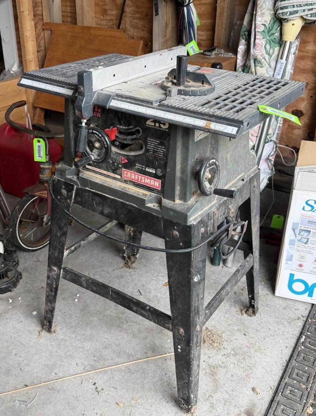 table saw on a black stand in a garage or workshop