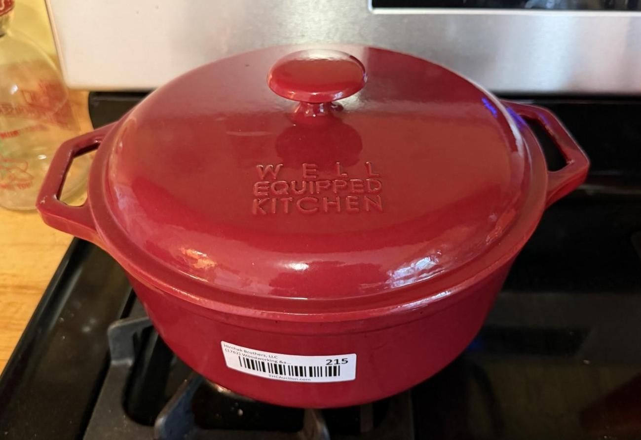 Red Dutch oven with lid on a stovetop