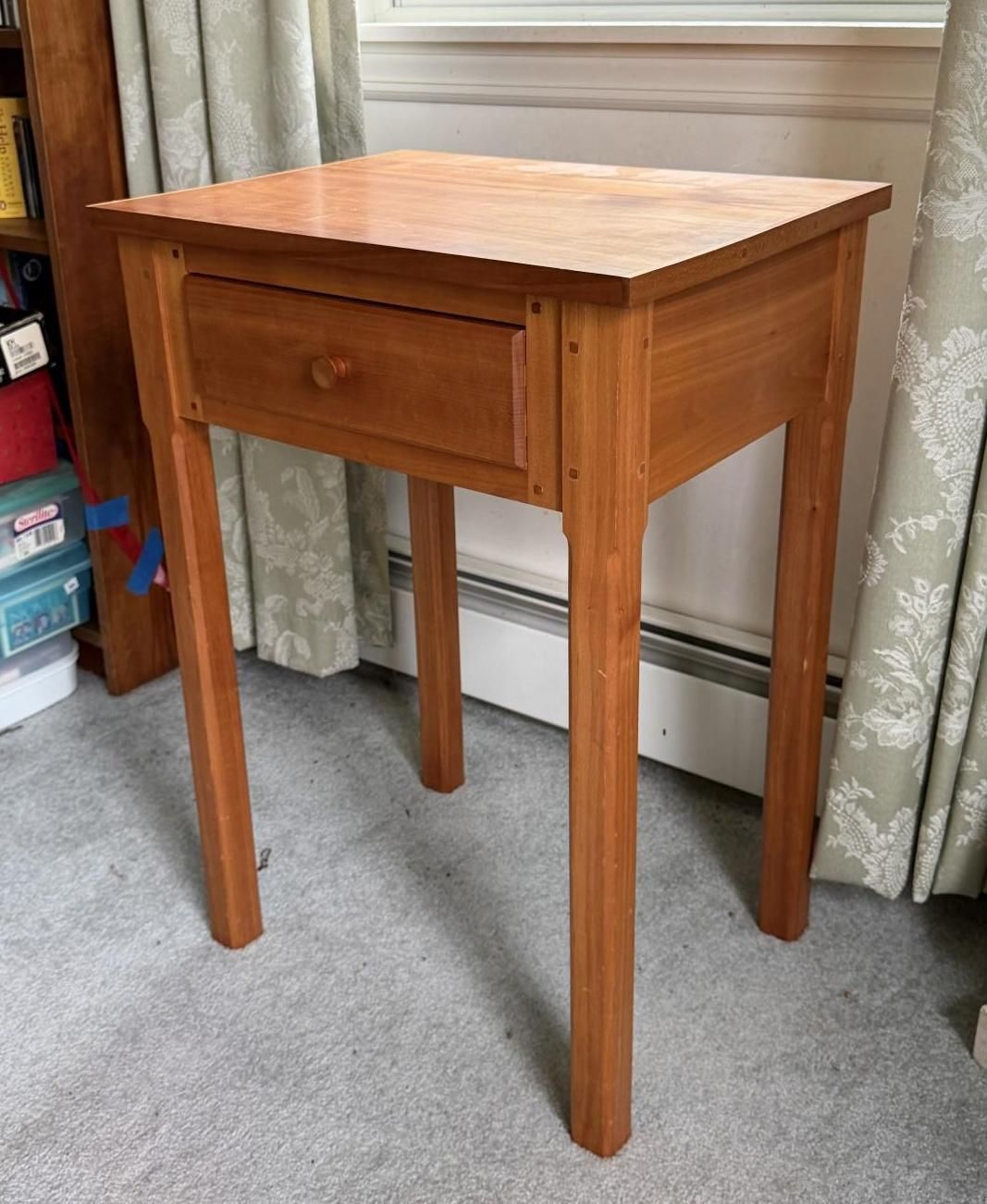 Small wooden side table with a drawer