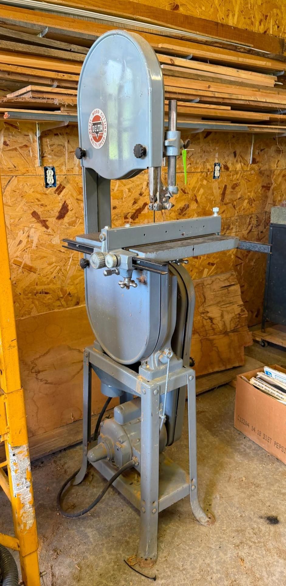 band saw in a workshop with a gray metal frame
