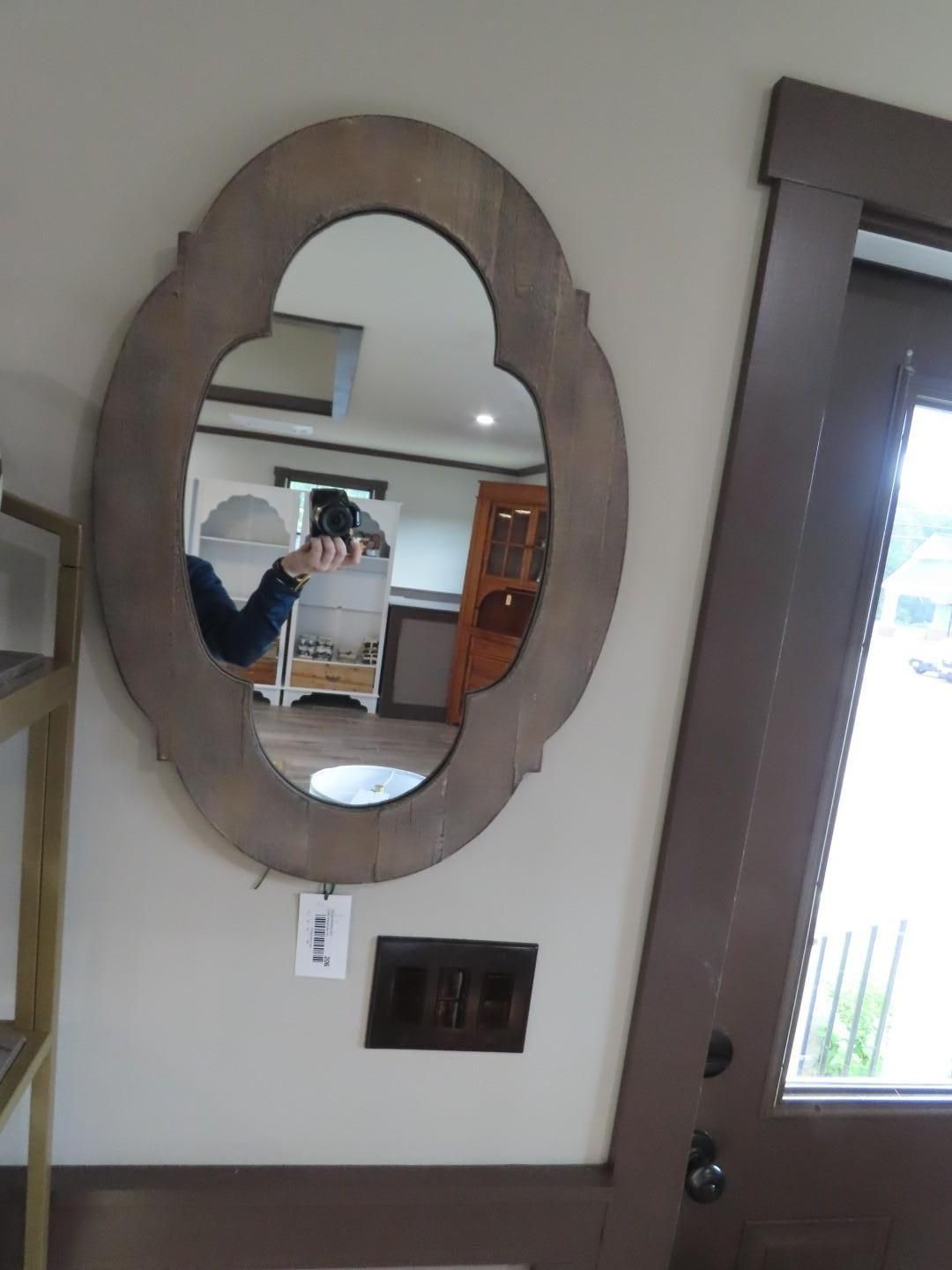 Oval mirror on a beige wall
