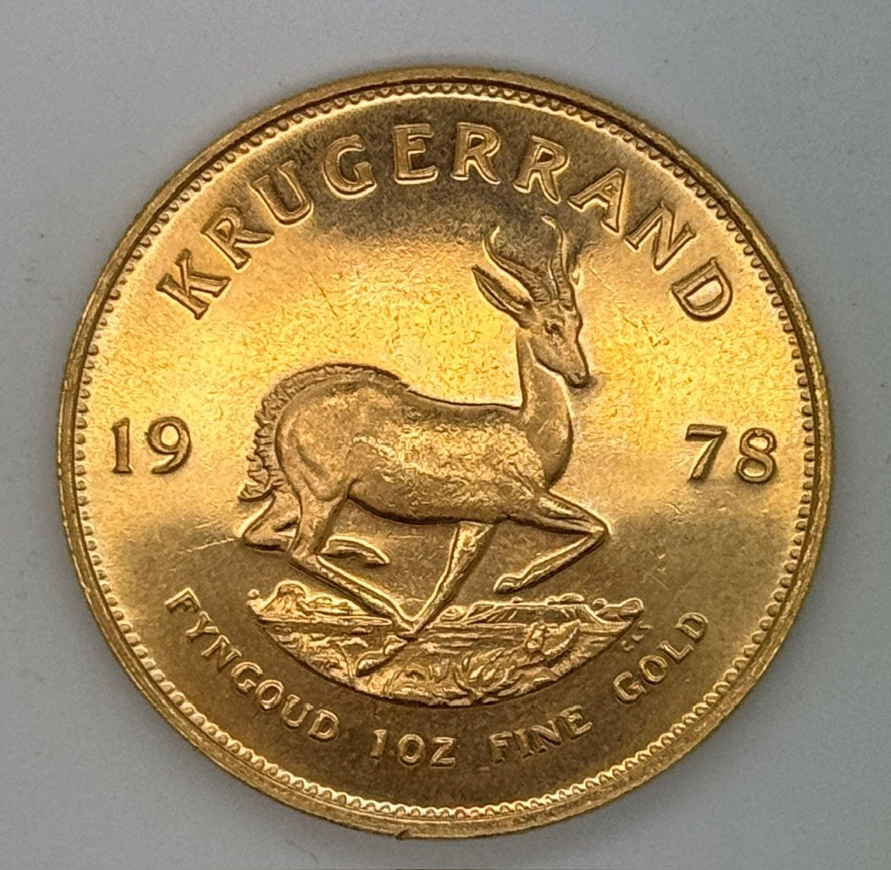 1978 Krugerrand gold coin with springbok antelope and “FYNGOUD 1 OZ FINE GOLD” inscription
