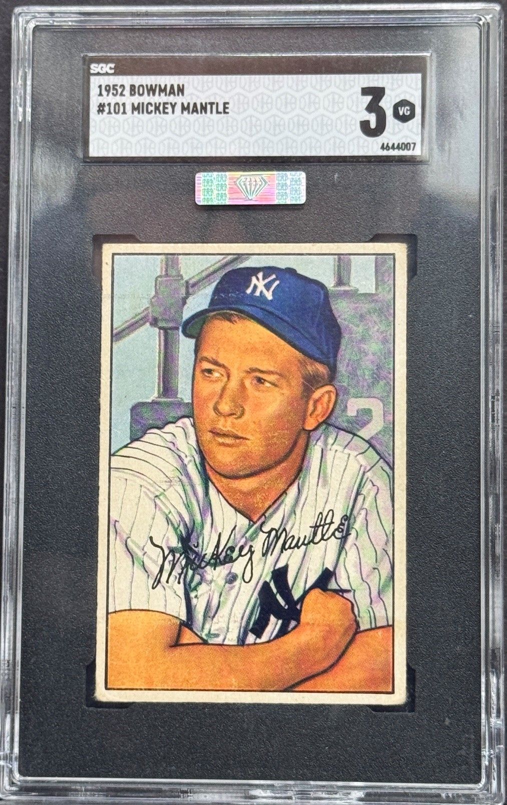Graded vintage baseball card with a portrait of a Yankees player in a blue cap and pinstripe jersey.