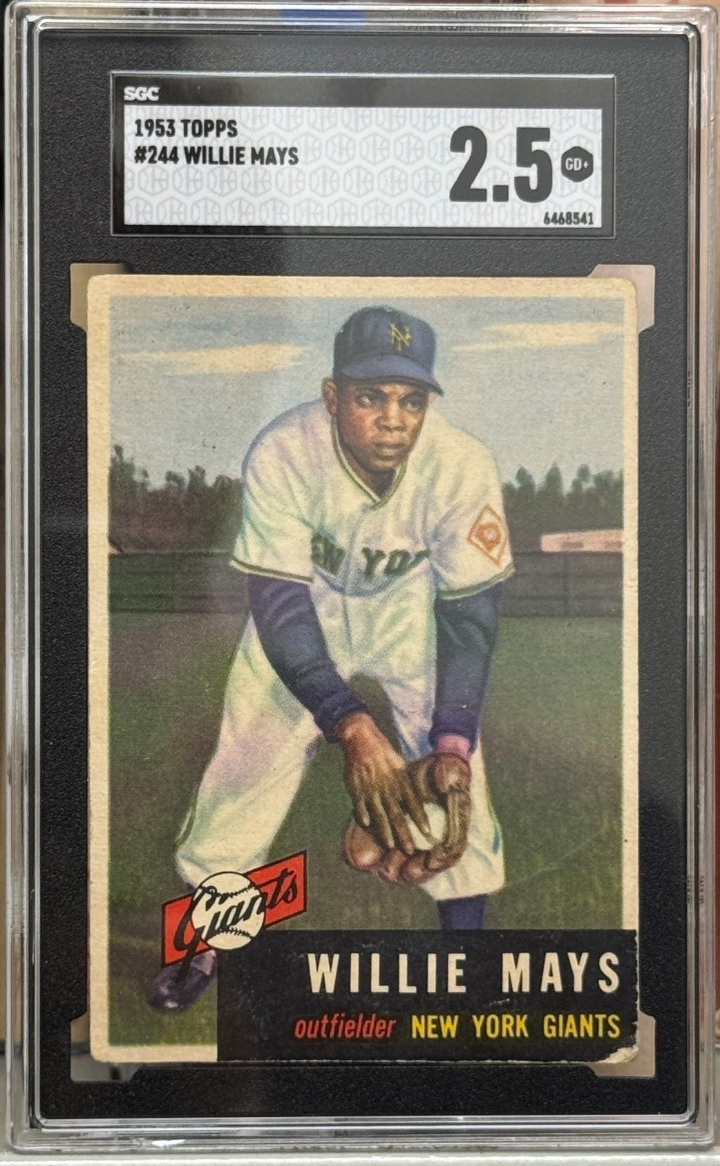Vintage Willie Mays baseball card in Giants uniform, crouching in a fielding pose