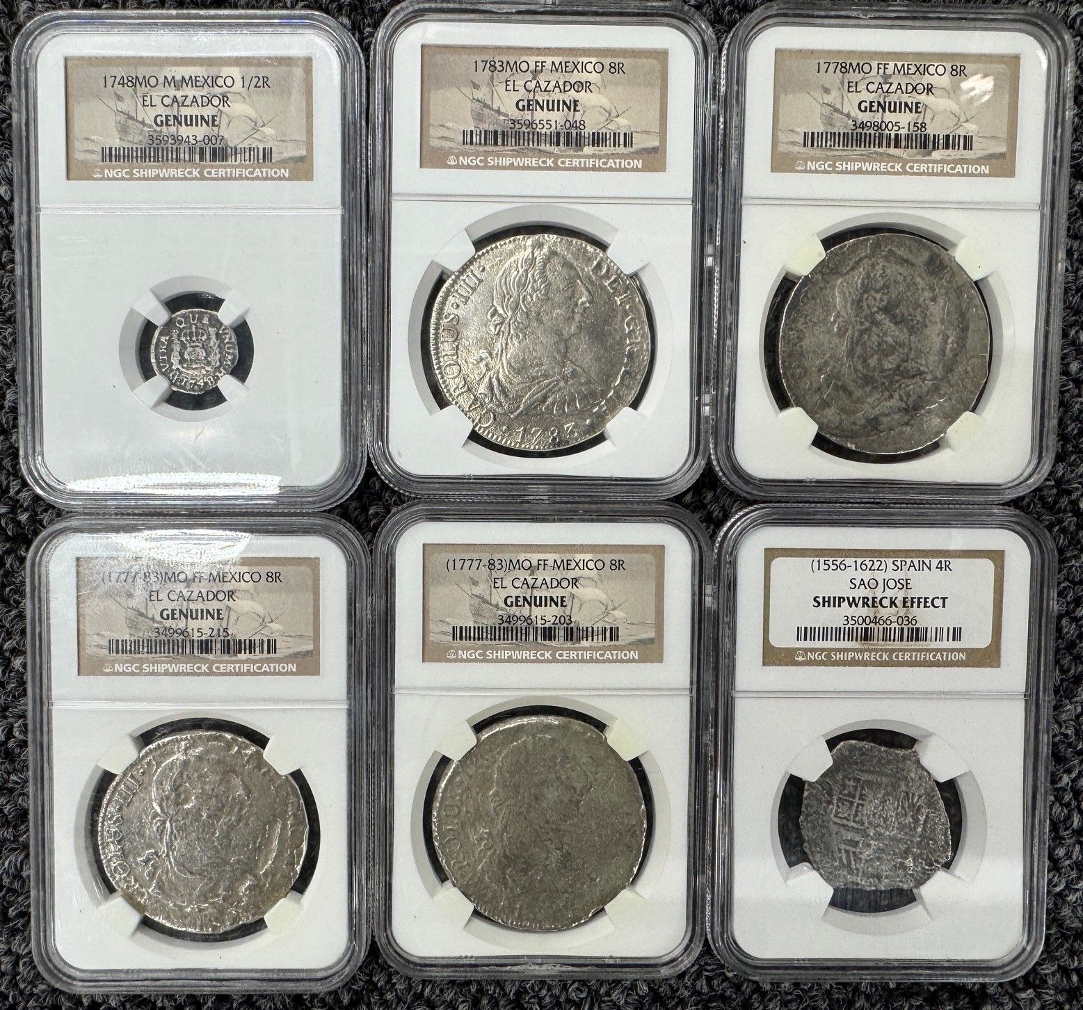 Six graded coin slabs arranged in two rows on a dark background