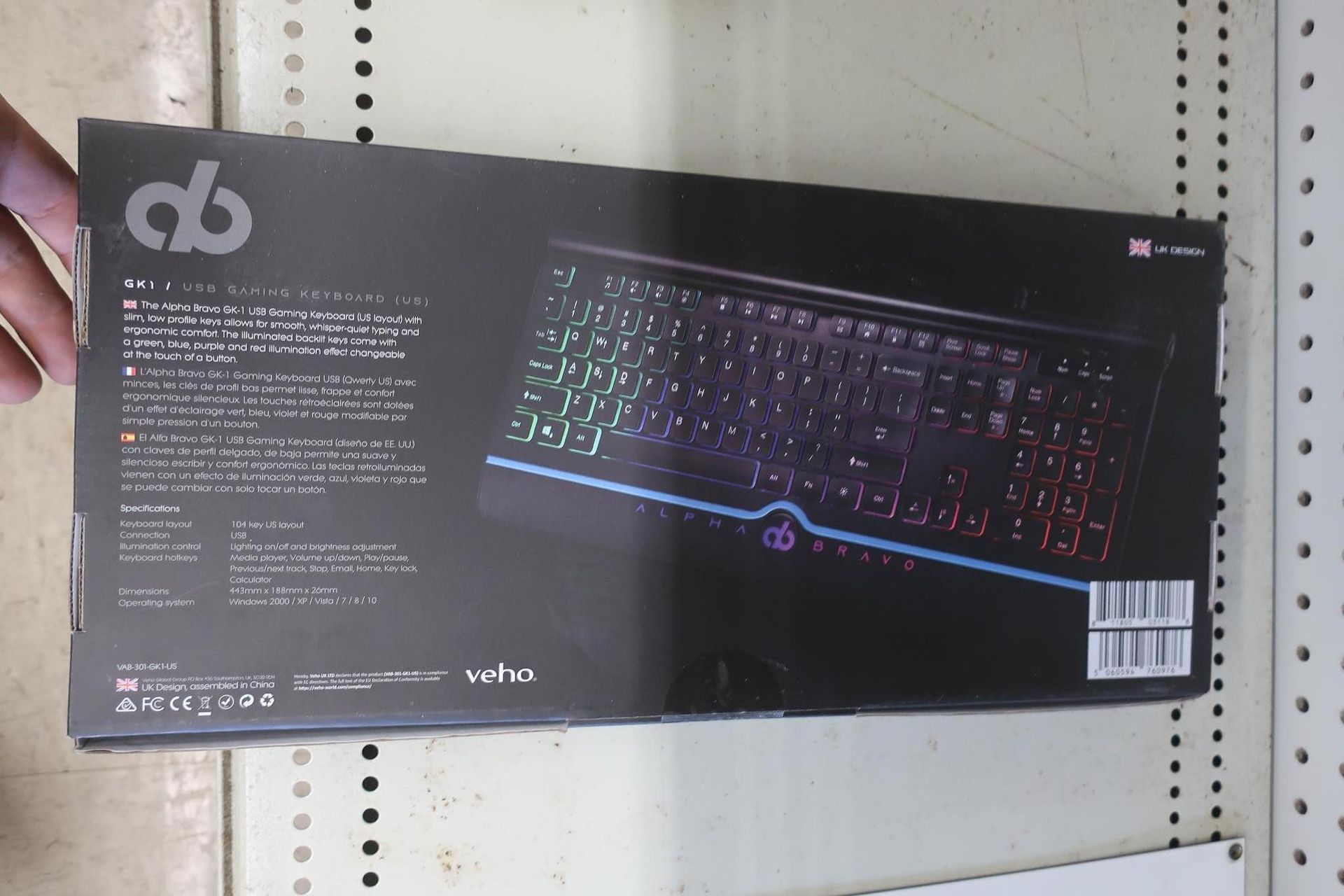Keyboard box with colorful illuminated keys. Black box on a shelf.