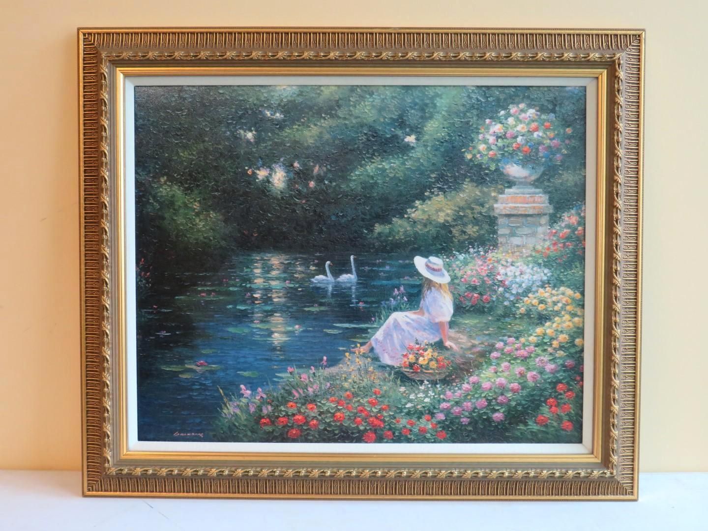 Woman in white dress by a pond, framed painting with swans and flowers, gold frame.
