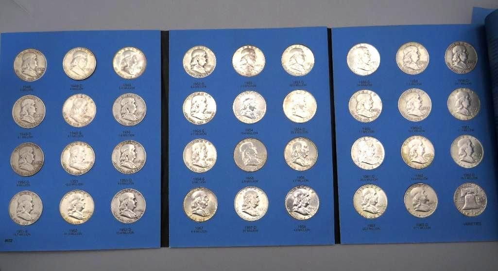 Three blue coin album pages with multiple silver coins in each slot.