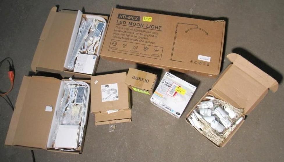Cardboard boxes containing LED moon light components on a surface.
