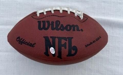 Brown Wilson NFL official football, laces up, on a white surface.