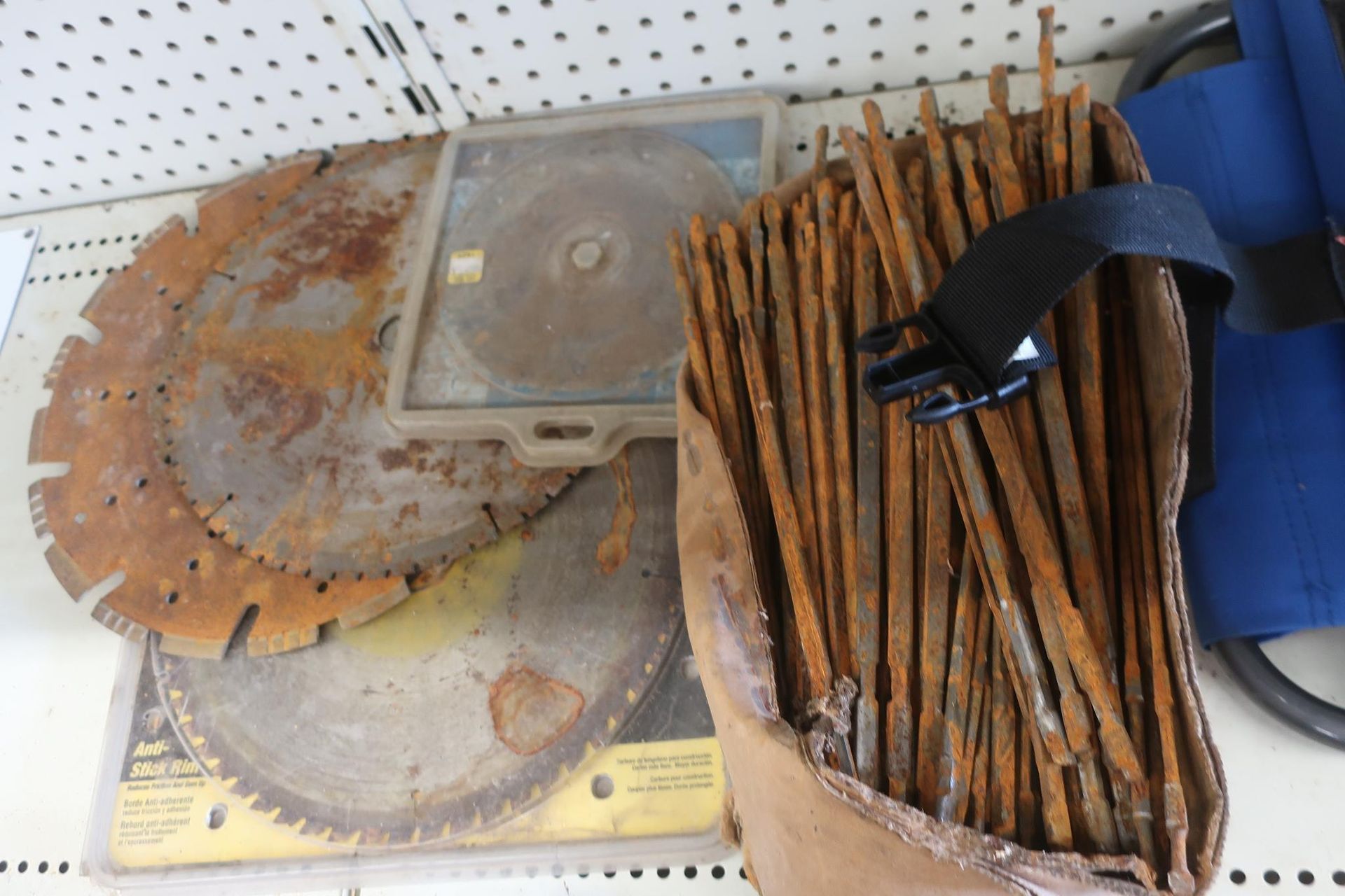 Pile of saw blades and metal stakes.
