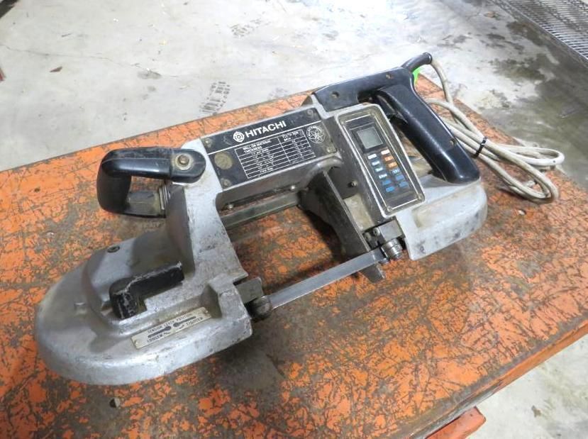 Hitachi band saw on an orange surface.