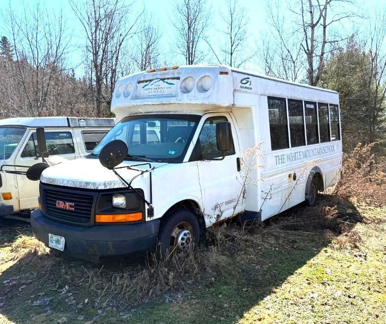 White school bus parked outside.