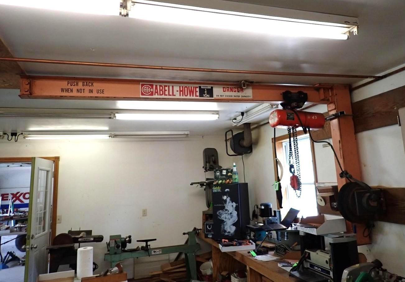 Garage interior with an orange overhead crane.