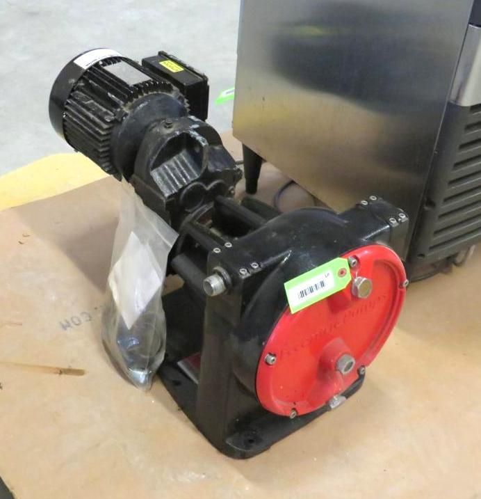Black and red industrial pump with an attached electric motor, sitting on a surface.