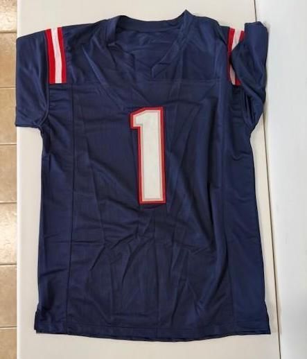 Navy football jersey with number 1 on back, red and white stripes on shoulders.