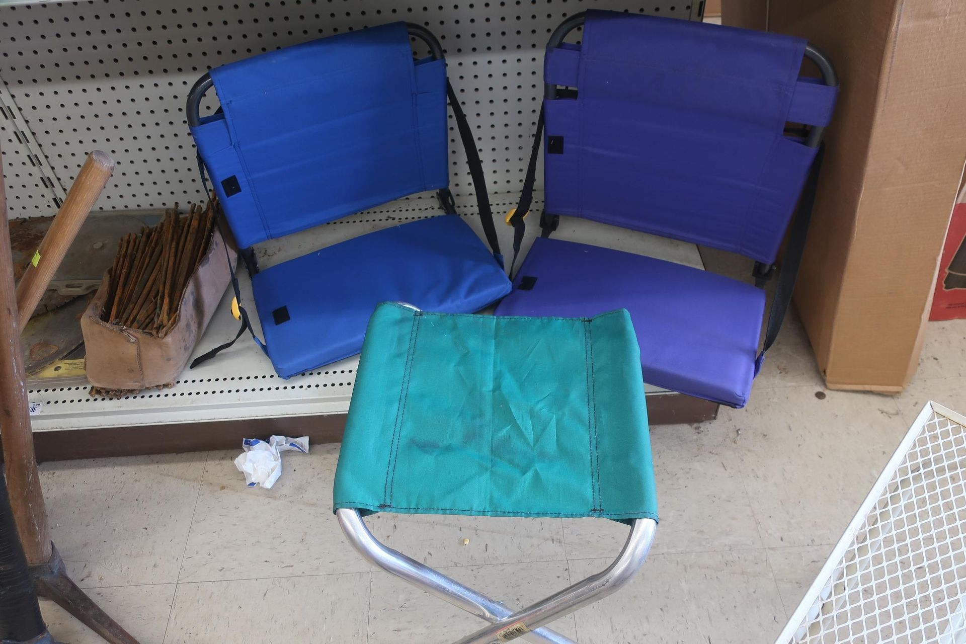 Three camping chairs: two blue and one green.