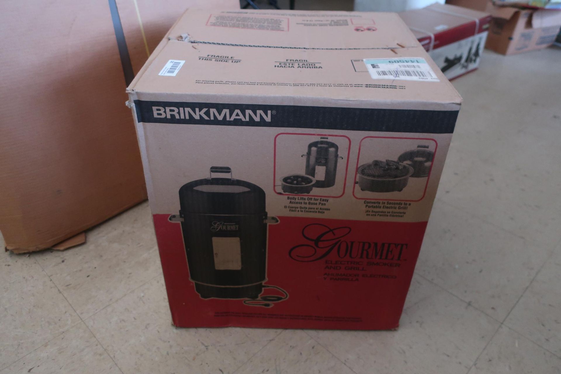 Boxed Brinkmann Gourmet charcoal smoker. Black and red box, product image visible.