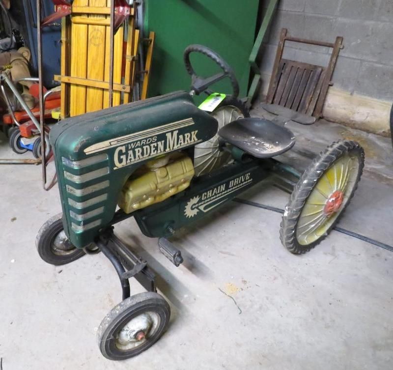 Green and silver pedal tractor toy labeled 