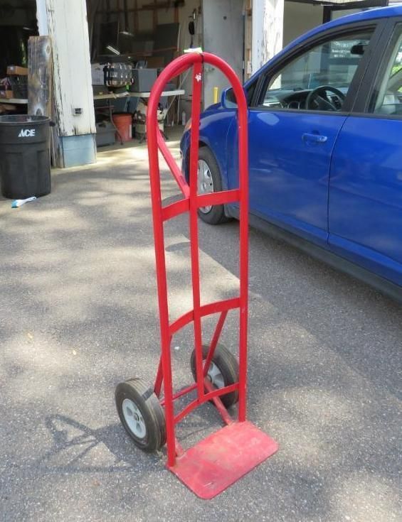 Red hand truck with wheels.