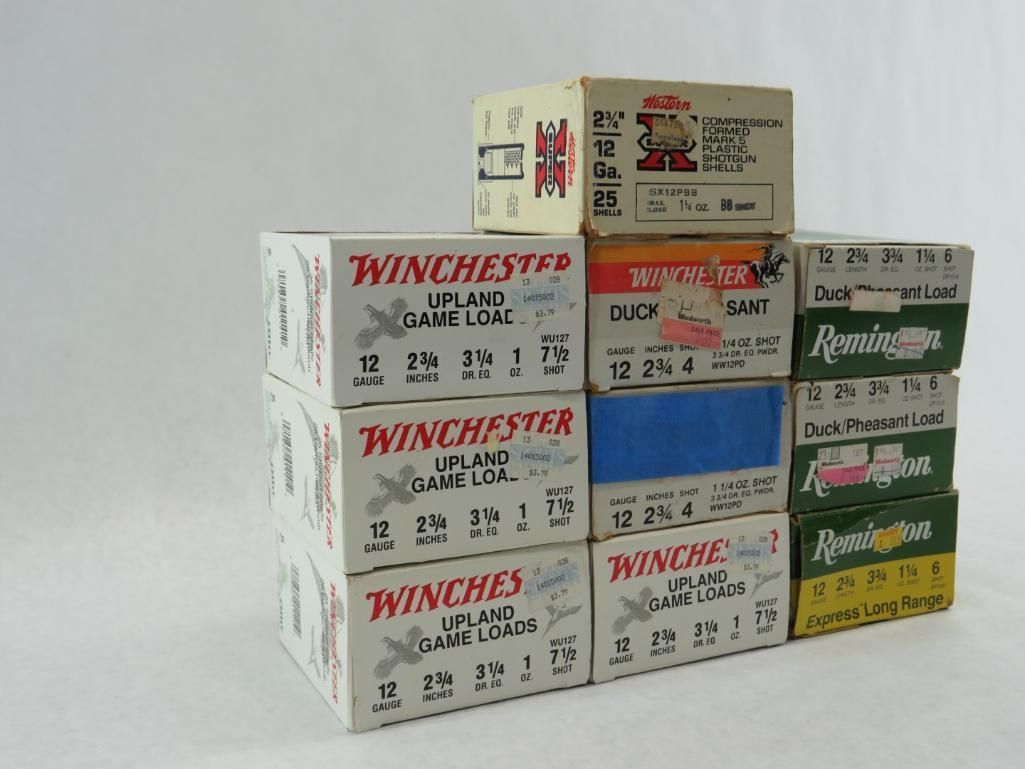 Stack of vintage shotgun shell boxes, featuring various brands and colors.