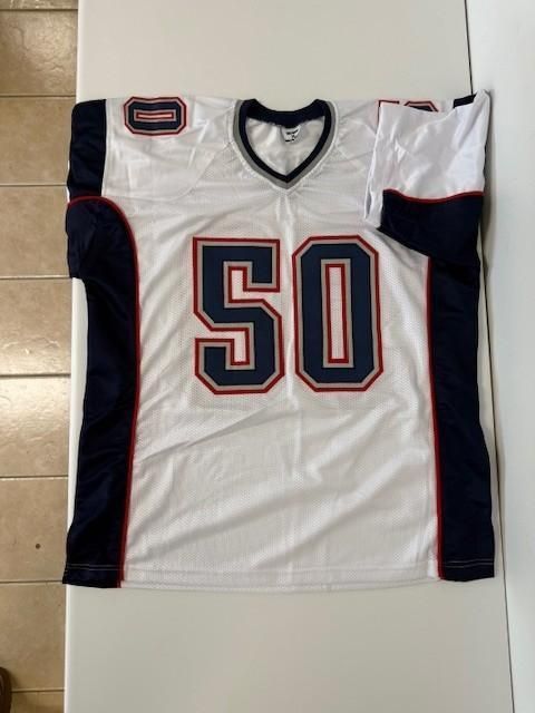 White football jersey with the number 50 in navy and red trim; navy side panels.