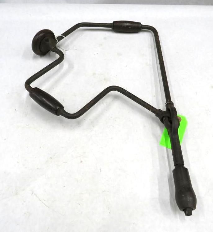 Hand drill with a wooden handle, crank, and chuck.