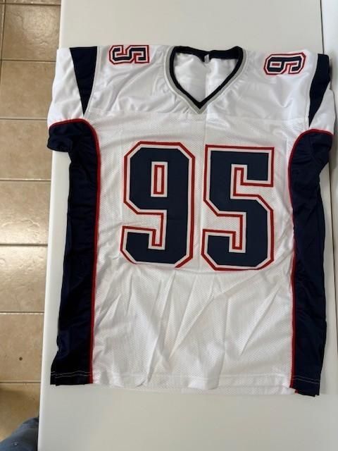 White and blue football jersey with number 95. Red accents, navy blue sleeves.