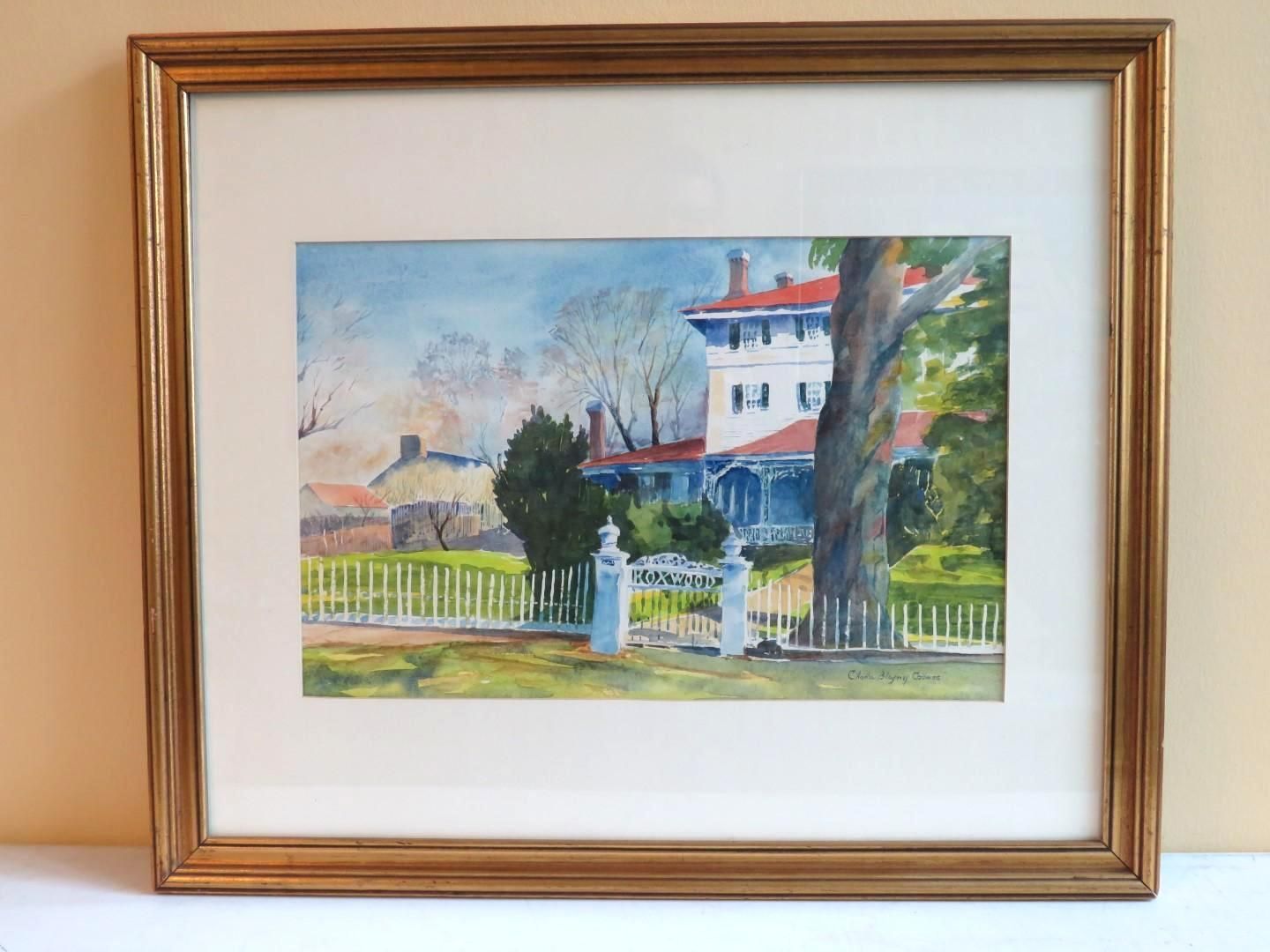 Watercolor painting of a white house with a red roof, behind a white picket fence, under a blue sky.