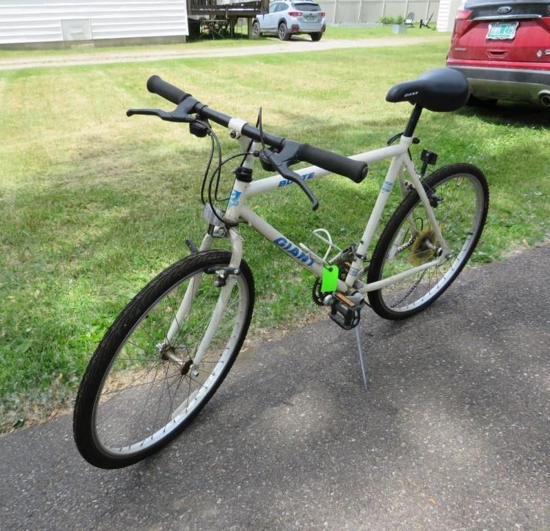 White Giant mountain bike on a paved driveway.