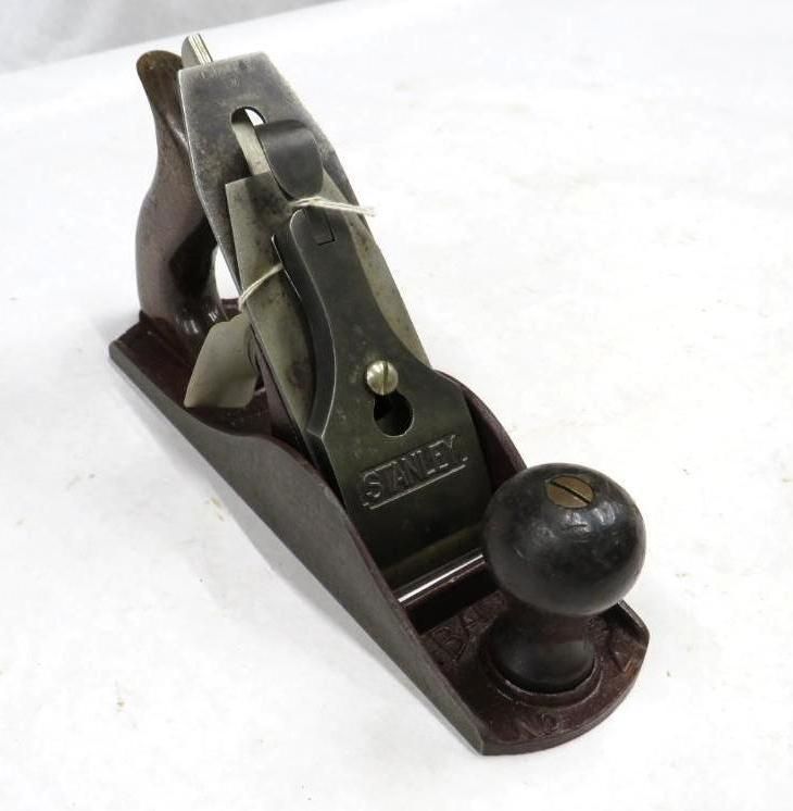 Stanley hand plane on a white surface.