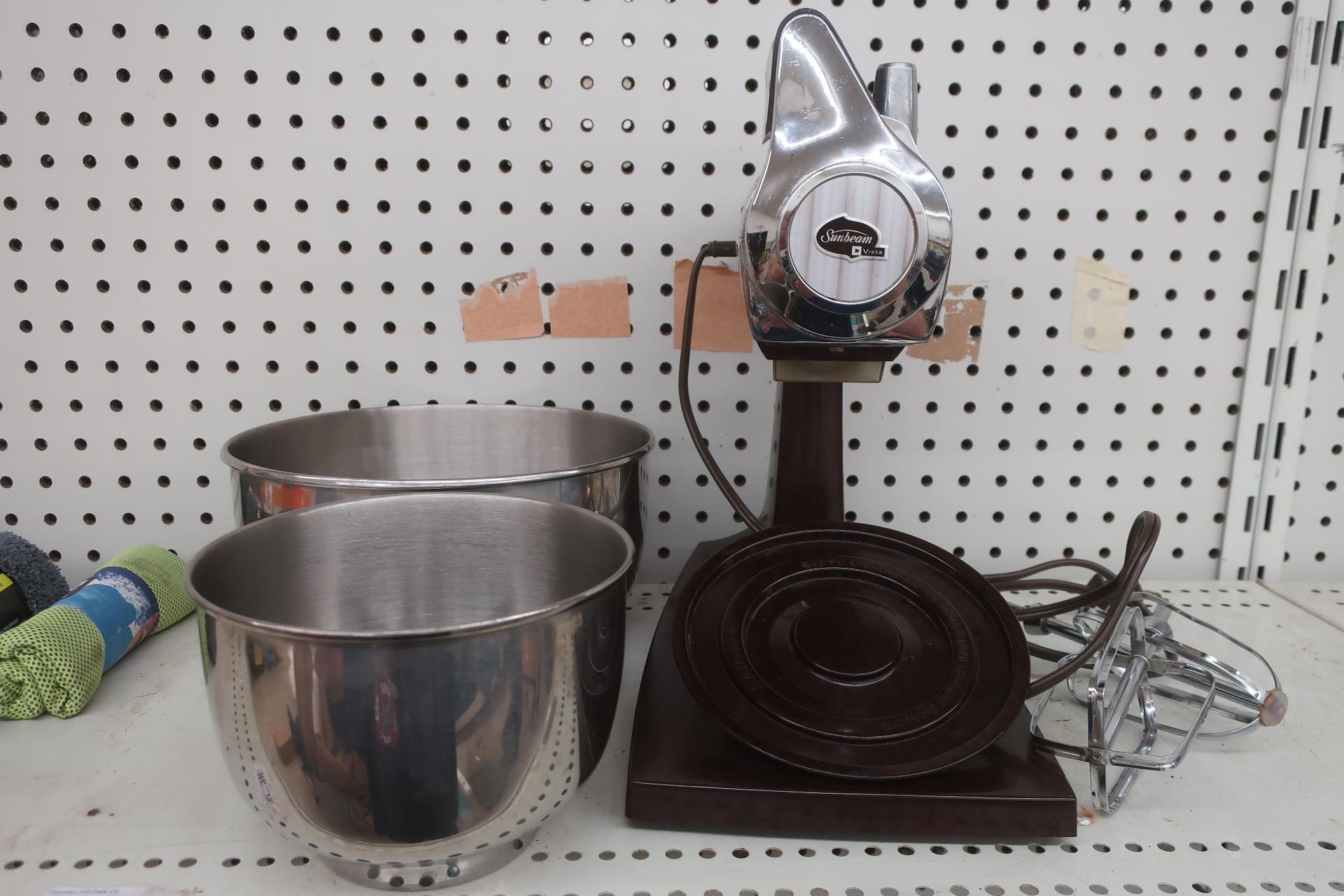 Vintage electric stand mixer with two stainless steel bowls, and a wire whisk.