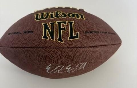 Brown Wilson NFL football with signature.