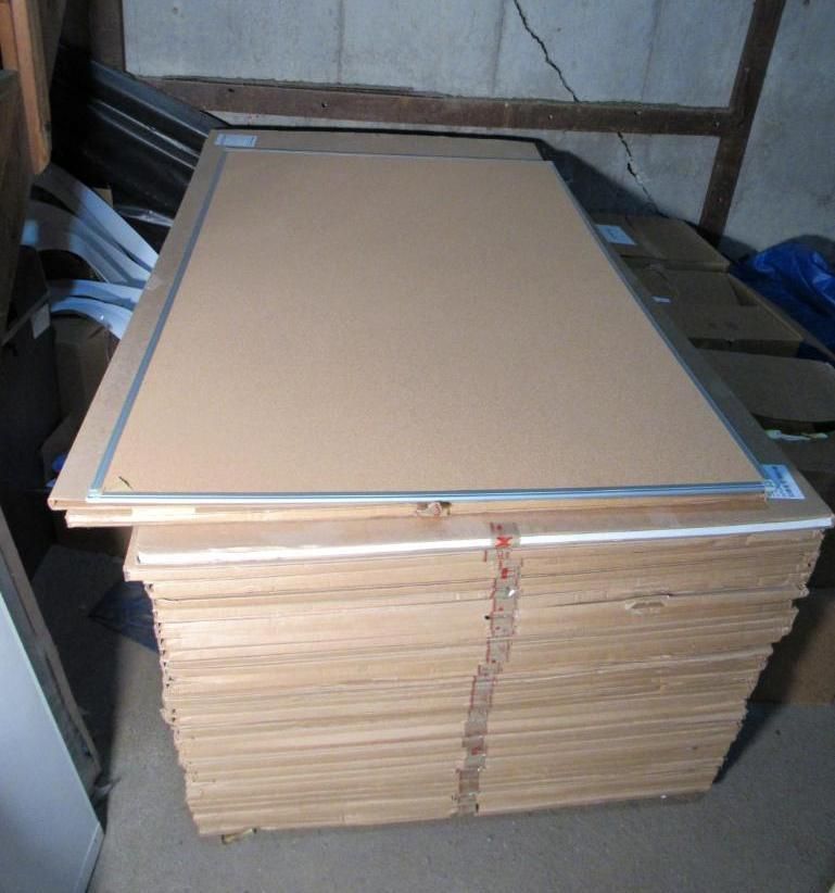 Stack of cardboard panels, possibly for framing, in a storage area.