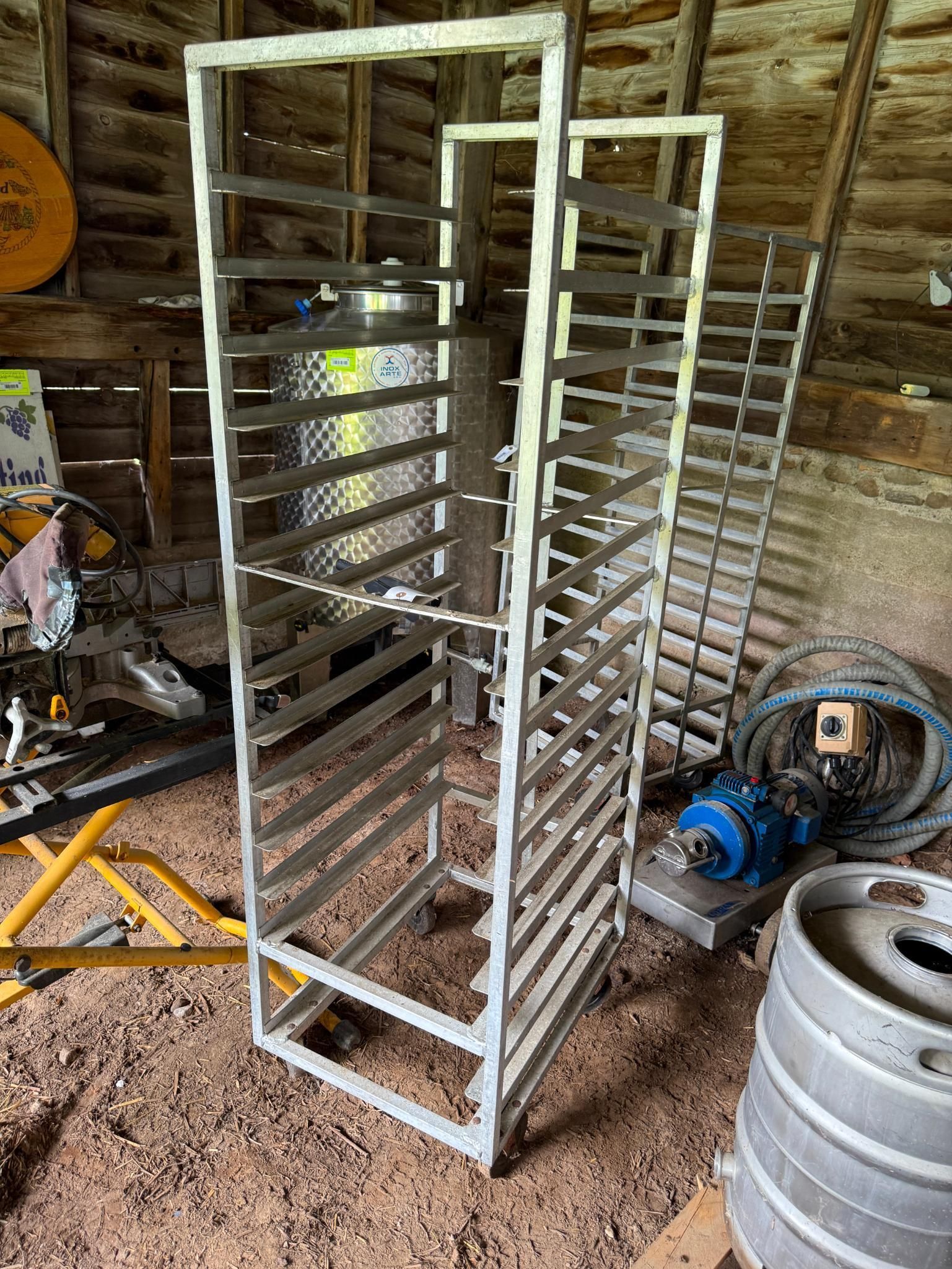 Two metal bakery racks on wheels.