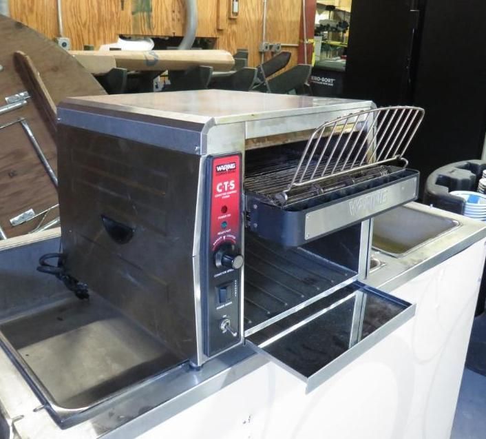 Commercial toaster with adjustable rack, stainless steel, in kitchen setting.