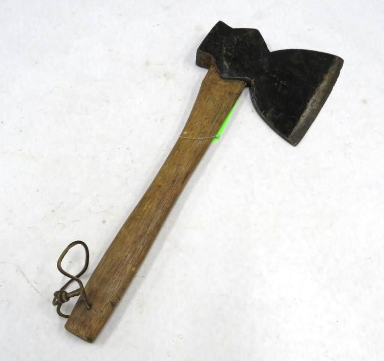 Small axe with a dark metal head and wooden handle, lying on a white surface.