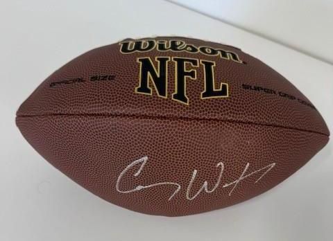Brown NFL football with a signature from Corey Webster.
