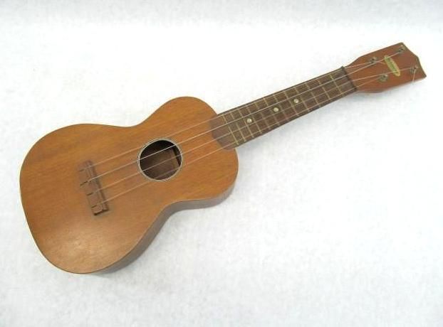 Wooden ukulele on a white background.