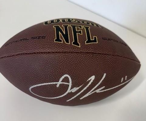 Brown NFL football with a white signature.