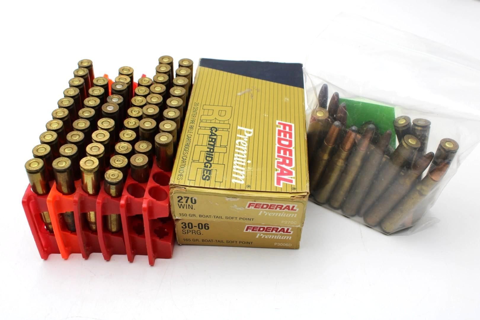 Boxes of ammunition and rifle cartridges on a white surface