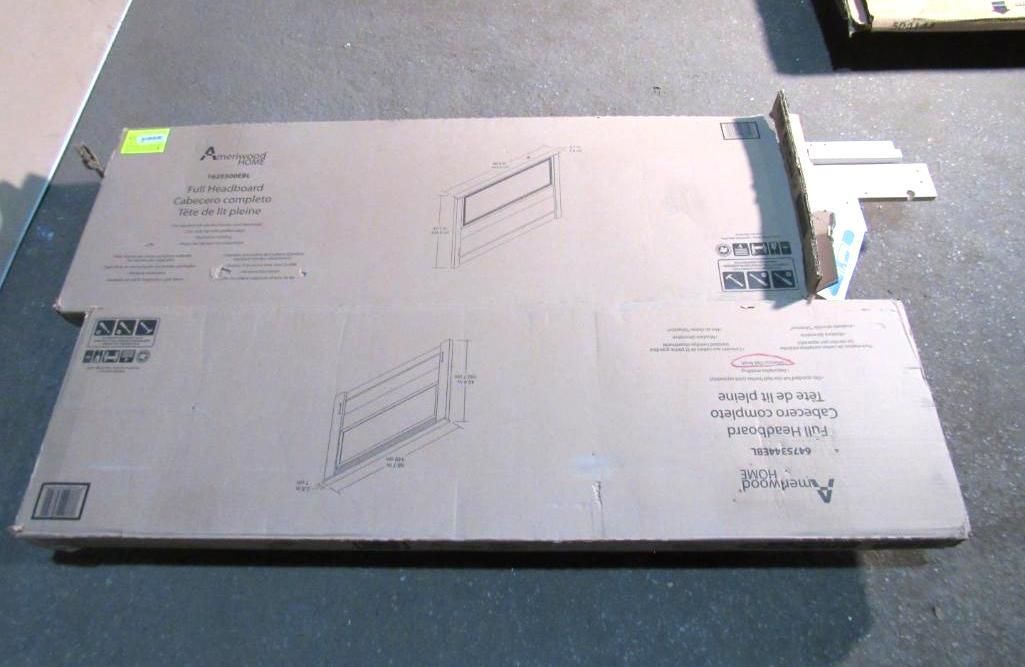 Two cardboard boxes, stacked, with product drawings. Gray surface.