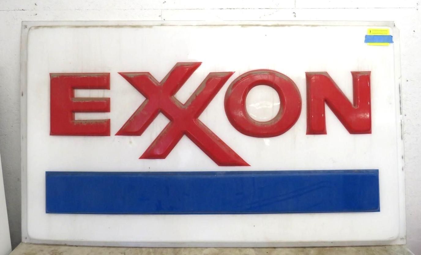 Exxon sign with red letters on a white background, and a blue stripe at the bottom.