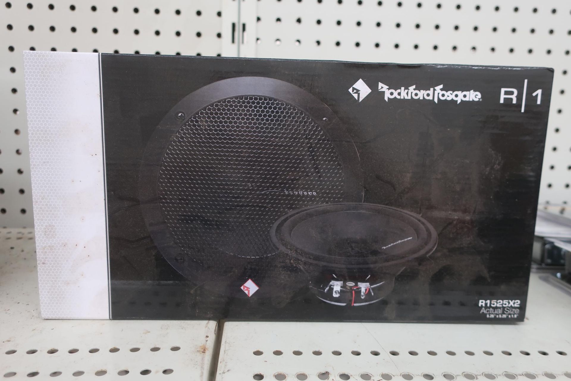 Box for a Rockford Fosgate R1 speaker, black and white, on a store shelf.